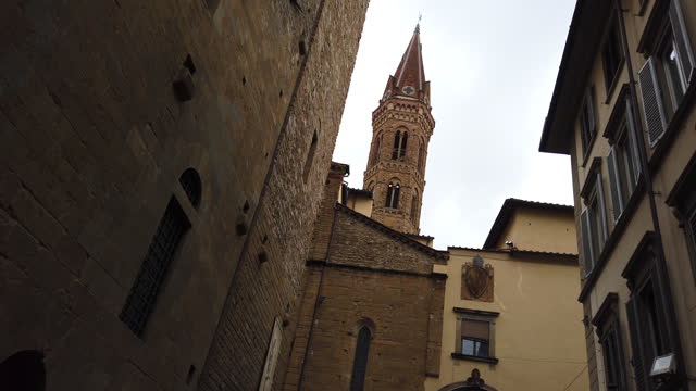 Walking point of view of cozy narrow street in Florence