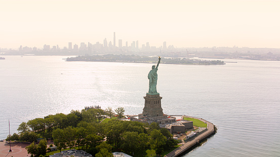Aerial view of Statue of Liberty in front of city, New York City, New York State, USA.