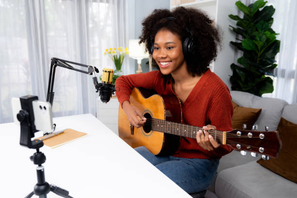 istock Host channel of African greeting on smartphone on broadcast studio. Tastemaker. 2086021793