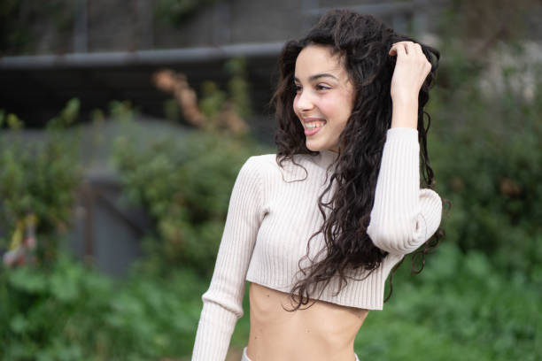 Happy young woman smiling and enjoying a sunny day. One person, Outdoors.