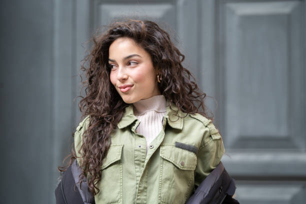 Woman whom is in her United Air Force flight uniform poses in a rustic background.