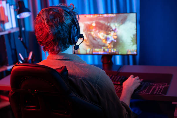istock Young gaming streamer playing fighting Moba, wearing headphone and mic. Gusher. 2086048565