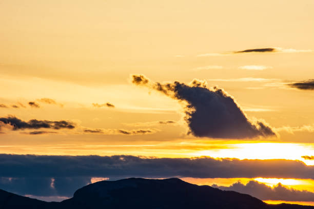 Warm colors of the sky and  cold clouds above the Dinarides at sunset. Photo taken on March 14, 2024 in Livno, Bosnia and Herzegovina