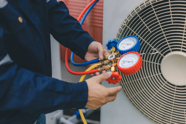 istock Technician is checking air conditioner. Air conditioning, HVAC service technician using gauges to check refrigerant and add refrigerant. 2086062516