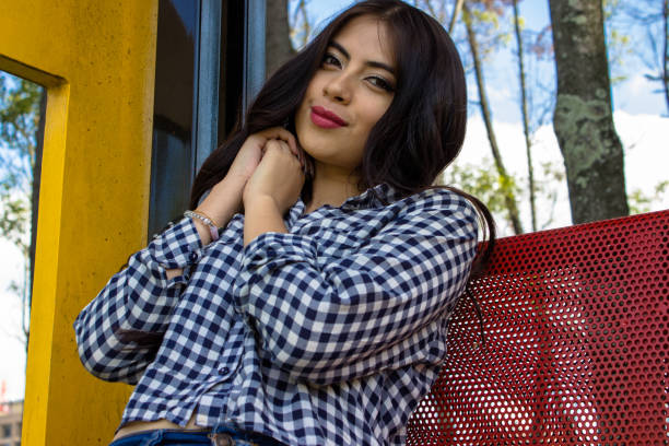 Beautiful young woman posing in a public park