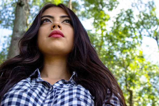 Beautiful young woman posing in a public park