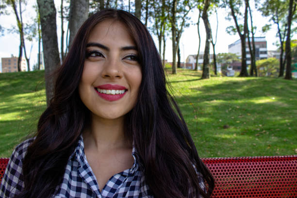 istock Beautiful young woman posing in a public park 2086087800
