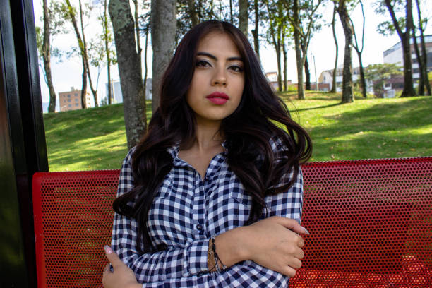 Beautiful young woman posing in a public park