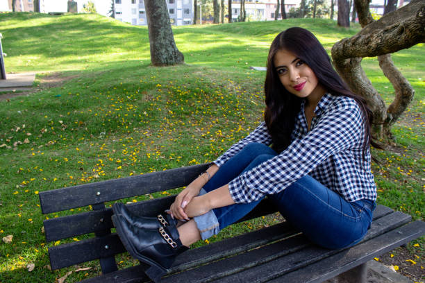 Beautiful young woman posing in a public park