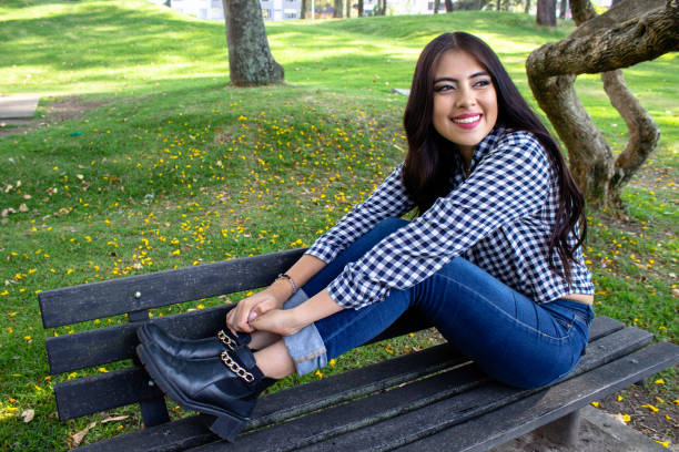 Beautiful young woman posing in a public park