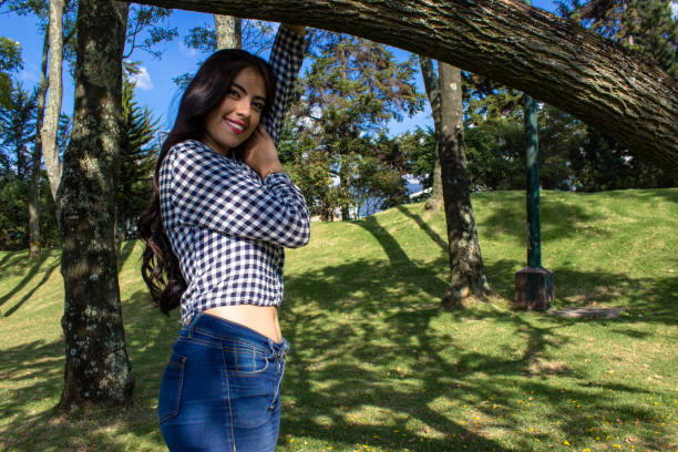 Beautiful young woman posing in a public park