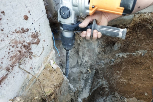 istock Construction industry worker using pneumatic hammer drill to cut the wall concrete brick, close up 2086122290
