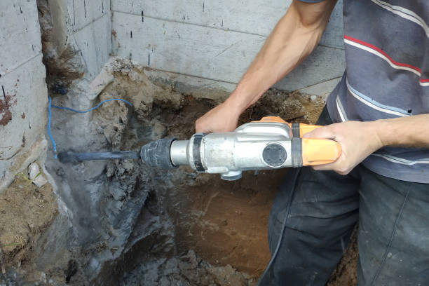 istock jackhammer in action, pneumatic construction tool, drilling a hole in the concrete wall. 2086122819