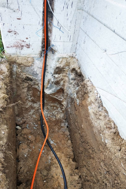 istock The workman will shield the electric cable in the trench. 2086125451