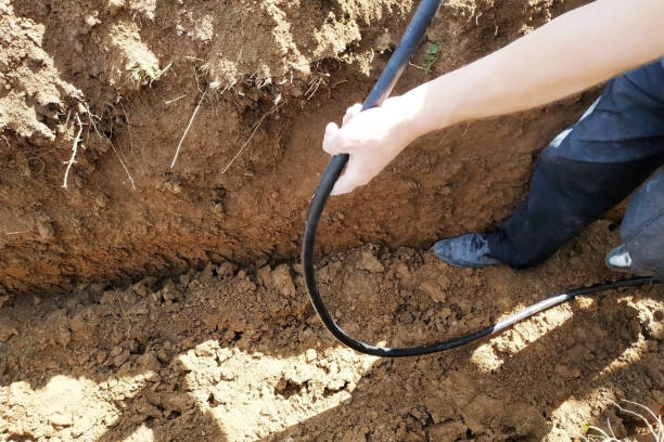 istock The workman will shield the electric cable in the trench. 2086126228