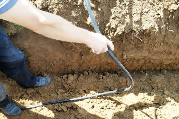 istock The workman will shield the electric cable in the trench. 2086126517