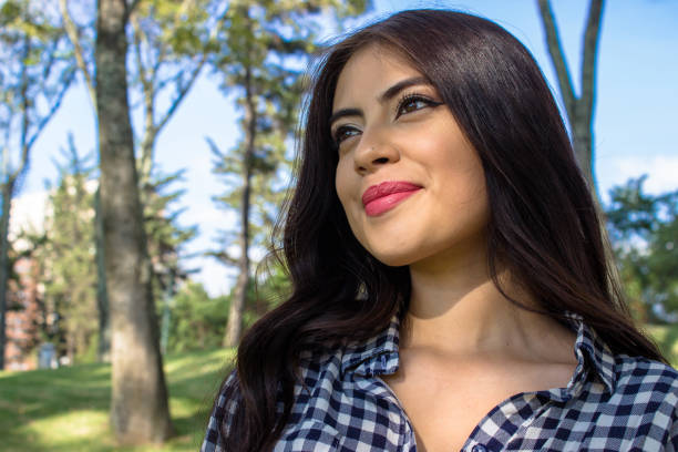 Beautiful young woman posing in a public park