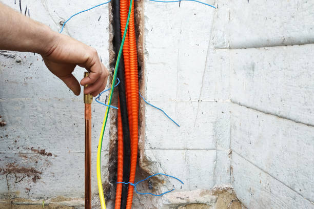 istock The electrician conducts electrical work on the current grounding of the current drain. 2086129377