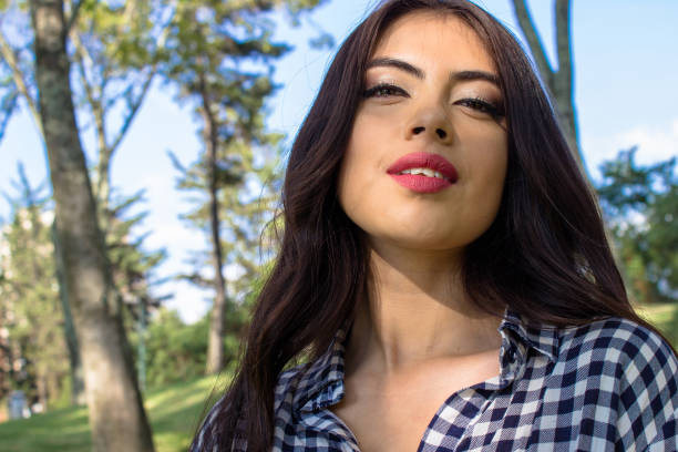 Beautiful young woman posing in a public park
