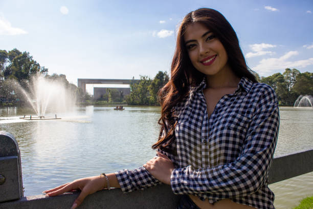 Beautiful young woman posing in a public park
