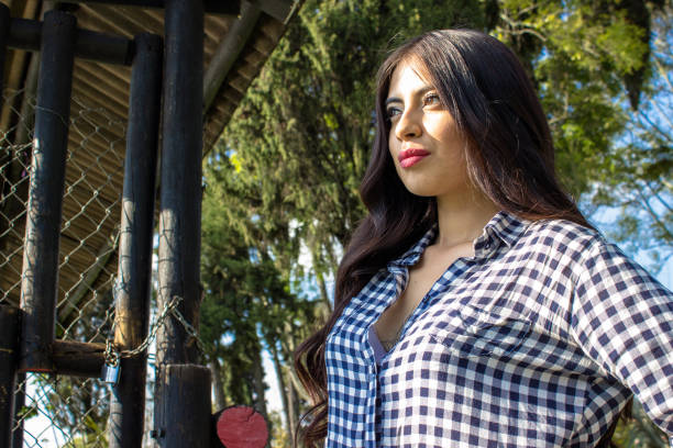 Beautiful young woman posing in a public park
