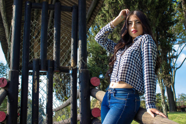 Beautiful young woman posing in a public park