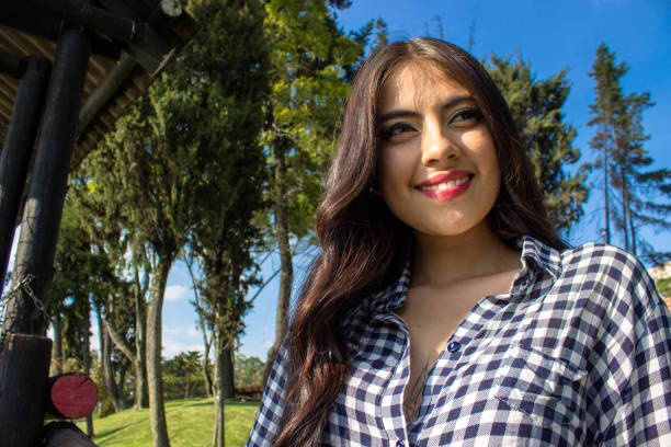Beautiful young woman posing in a public park