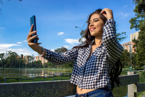 istock Beautiful young woman posing in a public park 2086139259