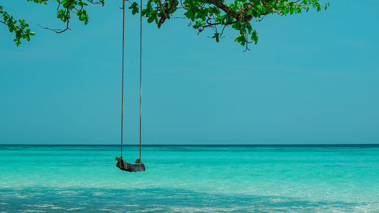 Swing over the water on a tropical island in Thailand. High quality photo