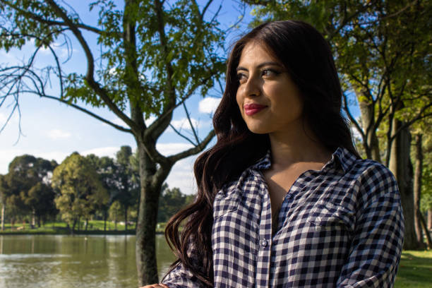 istock Beautiful young woman posing in a public park 2086145498
