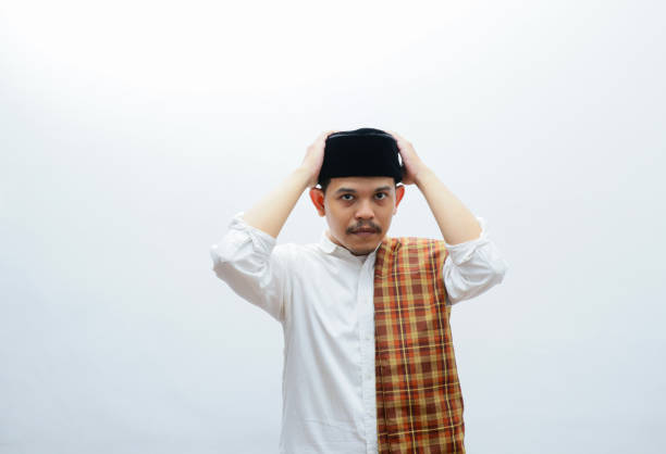 istock asian muslim man standing pose touching his cap 2086158260