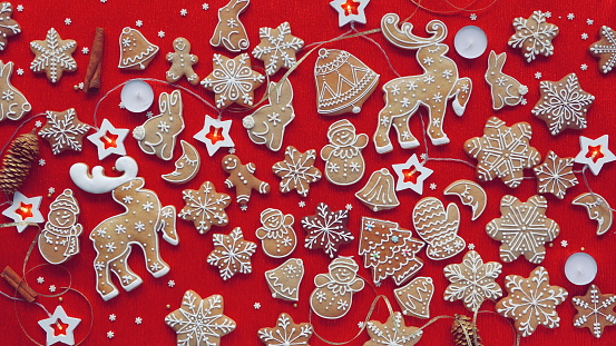 Festive Gingerbread Cookie Assortment on Red Background. A Delightful Spread of Holiday Treats with Decorative Icing and Christmas Cheer