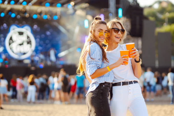 istock Two young woman with beer at beach party. 2086173087