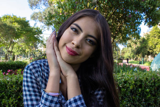 istock Beautiful young woman posing in a public park 2086173616
