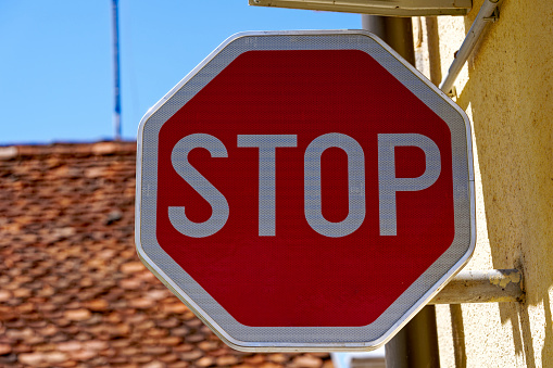 Close-up of stop sign at the old town of Kranj on a sunny summer day. Photo taken August 10th, 2023, Kranj, Slovenia.