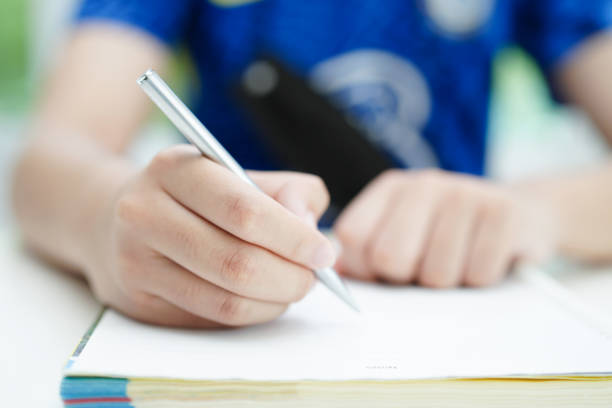 Asian teenage student write homework, study lesson for exam online learning education.