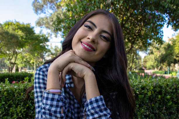 istock Beautiful young woman posing in a public park 2086191295