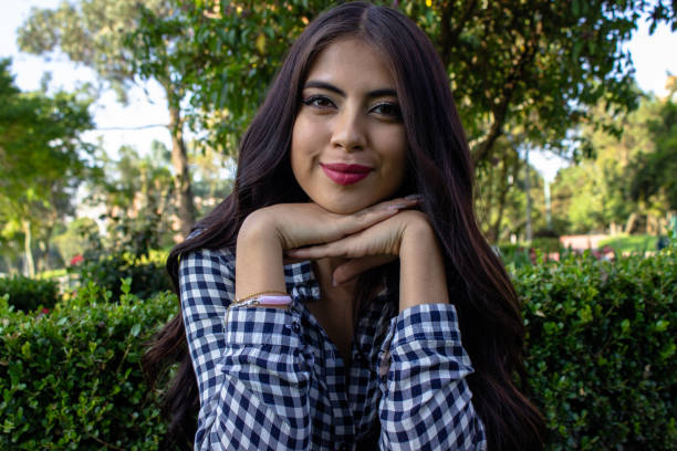 istock Beautiful young woman posing in a public park 2086191309