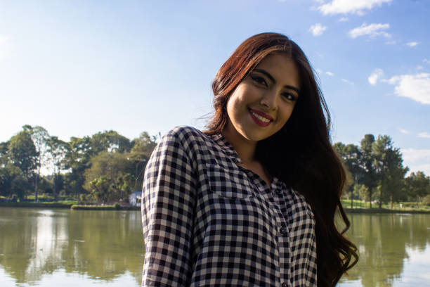 istock Beautiful young woman posing in a public park 2086191876