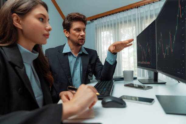 istock Two business traders consulting stock market, coworker taking note. Postulate. 2086196338