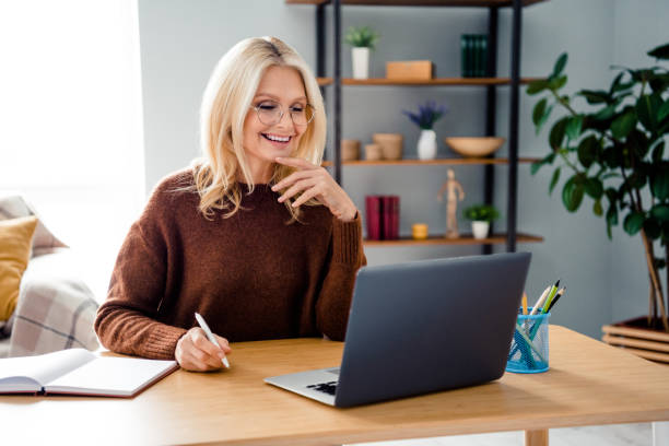 istock Photo satisfied job freelancer hold a pen in front of computer desktop pc when writing notes for self improvement isolated indoors office 2086212469