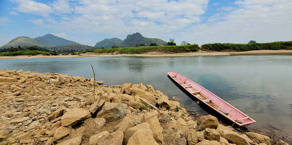 Pink rowboat in Khong river thr border between Thailand and Laos.