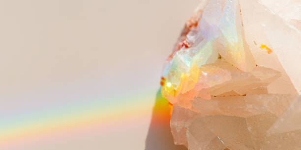 istock Luminous Quartz with Rainbow Flares. Sun's rays interact with quartz stone, iridescent rainbow glares, banner with shining crystal at sunlight, aesthetic view with natural light effect 2086241853