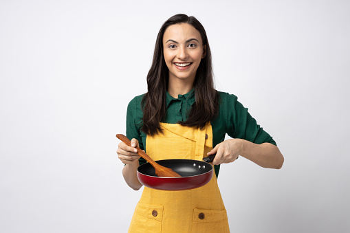 Portrait of Indian woman chef wearing apron isolated on white background