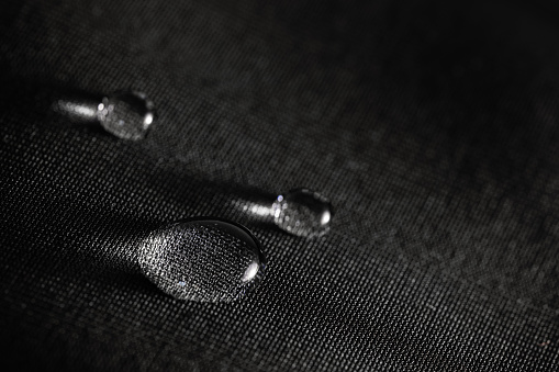 Many water drops on waterproof impregnated fabric.
