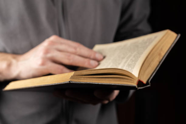 istock Man reading. Book in his hands. Close up 2086246254