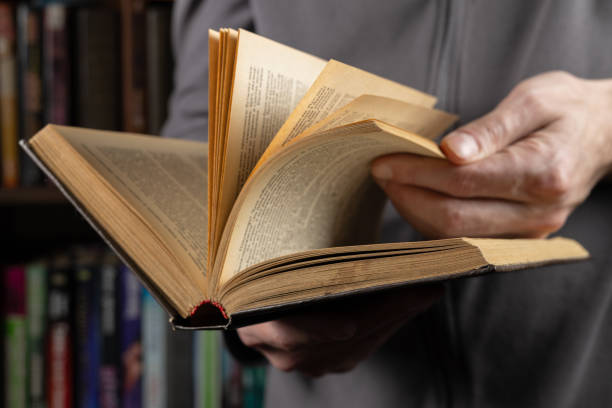 istock Man reading. Book in his hands. Close up 2086246257