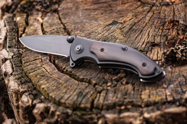 istock Tactical knife on a wooden background 2086254771