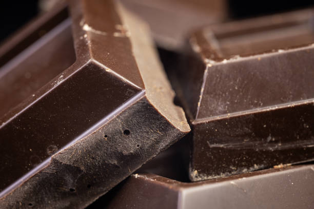 istock Broken chocolate. Chocolate pieces. Chocolate pieces on dark background. 2086259329