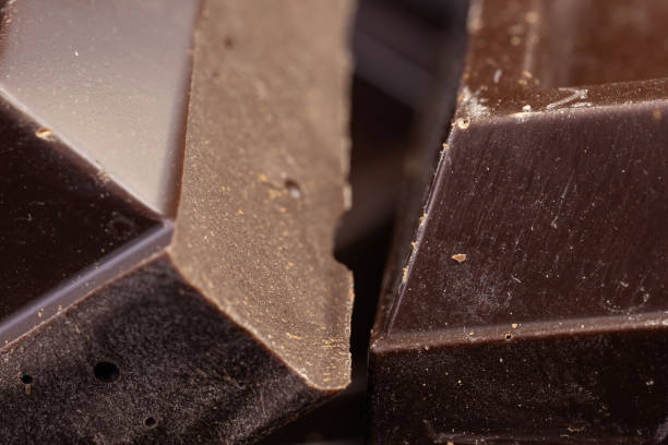 istock Broken chocolate. Chocolate pieces. Chocolate pieces on dark background. 2086259863